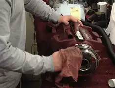 Vacuum repair technician cleaning and servicing a vacuum motor in Cambridge, MA
